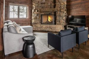 a living room with two couches and a fireplace at Big Sky Fire Towers - Two Home Compound - Sleeps 16! in Big Sky