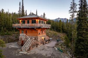 a log cabin in the middle of a forest at Big Sky Fire Towers - Two Home Compound - Sleeps 16! in Big Sky