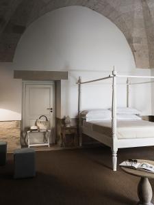 Postel nebo postele na pokoji v ubytování Don Totu - Dimora Storica