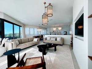 a living room with a couch and a table at Villa du golf in Sainte-Maxime