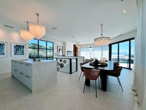 a kitchen with a table and a dining room at Villa du golf in Sainte-Maxime