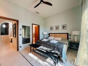 a bedroom with a bed and a ceiling fan at Villa du golf in Sainte-Maxime +16 photos