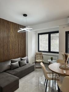 a living room with a couch and a table at La Vita Apartments by Sienna in Skopje