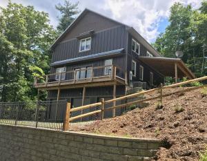 a house sitting on top of a hill at Unique Rustic Barn Theme home Amazing views! Luxe in Bailey Camp