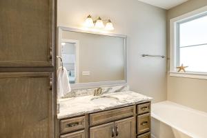 a bathroom with a sink and a mirror at 4 Mi to Marina and Boat Ramp Lake Murray Getaway! in Chapin +17 photos