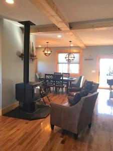 a living room with a fireplace and a dining room at Unique Rustic Barn Theme home Amazing views! Luxe in Bailey Camp
