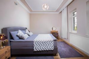 a bedroom with a bed and a chair and a window at Cappadocia Essa Orange Stone House in Nevsehir