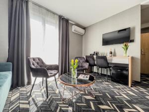 a living room with a couch and a table at Mielno Hotel Boutique in Mielno