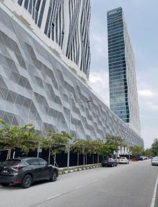 a large building with cars parked on a street at Penang Amazing SeaView Private Lift 梹城富人区绝美海景公寓私人电梯 in Tanjong Tokong
