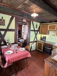 a kitchen with a table with a red table cloth at Gîte le Romantique in Colmar +47 photos
