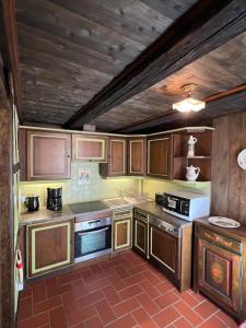 a large kitchen with wooden cabinets at Gîte le Romantique in Colmar