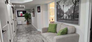 a living room with a couch and green pillows at Entire 2 Bedroom Apartment in Kitchener in Kitchener