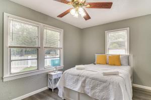 una camera con un letto, un ventilatore a soffitto e 2 finestre di 6 Mi to Busch Gardens Family and Pet Friendly Home a Tampa