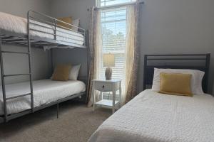 a bedroom with two bunk beds and a window at 3138 Laurel Drive in Gulf Breeze