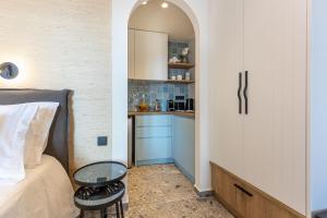 a bedroom with a bed and a small kitchen at Villa Angelo in Paleokastritsa +15 photos