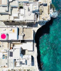 an aerial view of buildings and the ocean at View - Art house Roof top sea view in Polignano a Mare