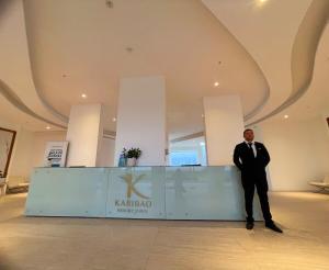 a man in a suit standing next to a counter at Karibao Ecusuites Double Room D in Playas +35 photos