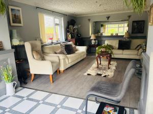 a living room with two couches and a table at Arch House in Florencecourt