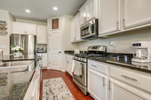 a kitchen with white cabinets and stainless steel appliances at 7 Mi to Dtwn Home with Fenced Yard in Roseville! in Roseville