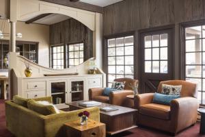 a living room with couches and a table at The Virginian Lodge, an Outbound Hotel in Jackson