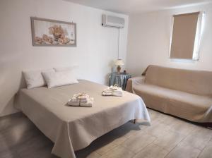 ein Schlafzimmer mit einem Bett und zwei Handtüchern auf einem Tisch in der Unterkunft Mola Cristina House in Mola di Bari