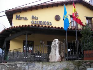 a building with two flags in front of it at Hotel Doña Gaudiosa in Pola de Lena