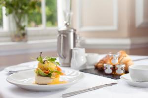 a white plate with a sandwich on a table at Bedford Hotel in Tavistock