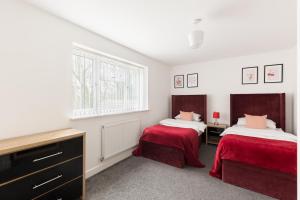 a bedroom with two beds and a window at Birmingham Estate - Contractor & Group Accommodation - Secure Parking in Birmingham