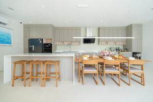 a kitchen with a table and some chairs and a counter at Elegant Nature villa with Private Swimming pool in Phuket Town