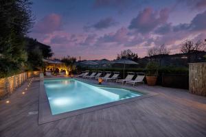 a swimming pool in a backyard with chairs around it at Residenza Marano 2B in Cupra Marittima