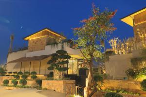 a building with a tree in front of it at The Borgo in Ludhiana