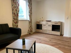 a living room with a couch and a table at Fewo Südeifel in Neuerburg