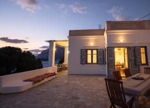 a white house with a table and chairs on a patio at Semini Villa in Kalymnos