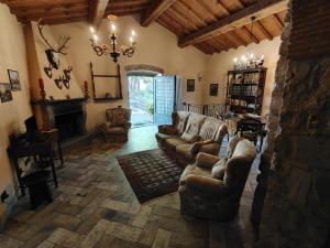 a living room with a couch and a fireplace at Bioagriturismo Podere Ruggeri in Pontassieve