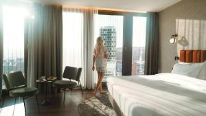 Un pat sau paturi într-o cameră la Radisson Blu Hotel at Porsche Design Tower Stuttgart