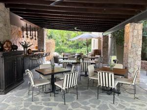 a patio with tables and chairs and a bar at Agua Bendita San Miguel de Allende in San Miguel de Allende