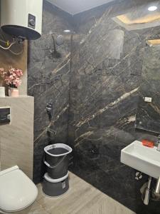 a bathroom with a toilet and a sink at Ultra Luxury Cool Flat By Bliss Stay in Ghaggar +52 photos