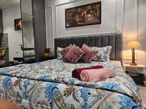 a bedroom with a large bed with pillows on it at Ultra Luxury Cool Flat By Bliss Stay in Ghaggar
