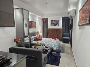 a hotel room with a bed and a desk at Ultra Luxury Cool Flat By Bliss Stay in Ghaggar