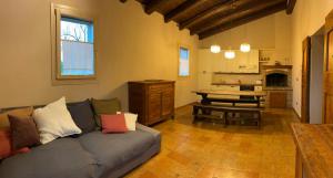 a living room with a couch and a table at Cà Sabbioso in Dozza