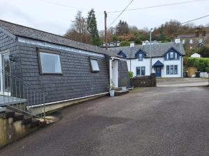 a house with a parking lot in front of it at Dunuaran in Oban