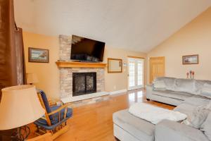 a living room with a couch and a fireplace at Game Room and On-Site Pond Laurelville Retreat! in Laurelville