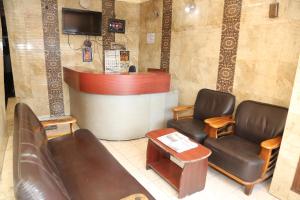 a waiting room with two chairs and a counter at DKS Lodge in Vellore