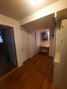 an empty living room with a table and a desk at Simply Suite - Sua Casa Longe de Casa in YYJ