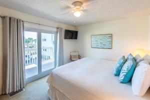 a bedroom with a bed and a window with a balcony at Whispering Sands 1A in Coffeyville