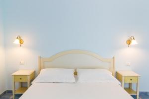 A bed or beds in a room at Baia dei Mulini Resort & Spa