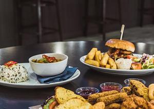 two plates of food on a table with plates of food at Whitehouse Holiday Park in Abergele