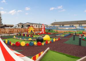 a playground with many different types of play equipment at Whitehouse Holiday Park in Abergele