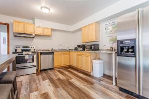 a kitchen with wooden cabinets and stainless steel appliances at Vintage with Advantages in Bryson City