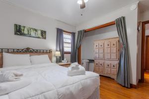 a bedroom with a large white bed and a door at Vintage with Advantages in Bryson City